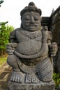 Vertical shot of a Hindu stone statue of a Gate Guardian Gupolo in Indonesia