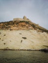 Vertical shot of historic castle ruins on a cliff over water at the Tremiti Islands in Puglia, Italy Royalty Free Stock Photo