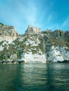 Vertical shot of historic castle ruins on a cliff over water at the Tremiti Islands in Puglia, Italy Royalty Free Stock Photo