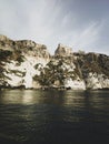 Vertical shot of historic castle ruins on a cliff over water at the Tremiti Islands in Puglia, Italy Royalty Free Stock Photo