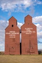 Vertical shot of Historic wooden grain elevators in the ghost town of Rowley, Alberta with blue sky