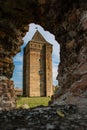 Vertical shot of the hole of the stone with the background of a medieval Bac fortress in Bac, Serbia Royalty Free Stock Photo