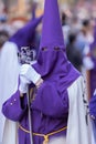 Vertical shot of a hooded penitent during the Holy Week in Madrid