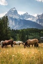 Vertical shot of horses grazing in a field in front of the Teton Mountains in Wyoming, USA Royalty Free Stock Photo