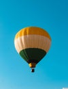 Vertical shot of a hot air balloon in a clear blue sky Royalty Free Stock Photo