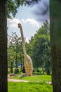 Vertical shot of a huge dinosaur statue in a park