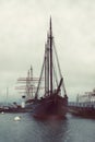 Vertical shot of a huge old ship in a dock captured on a cloudy day Royalty Free Stock Photo