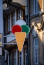 Vertical shot of an ice cream cone sign on the wall of an ice cream shop Royalty Free Stock Photo