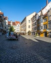 Vertical shot of an idyllic cobblestone plaza with colorful buildings in Lindau, Germany