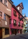Vertical shot of an idyllic cobblestone street with colorful buildings in Lindau, Germany