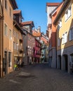 Vertical shot of an idyllic cobblestone street with colorful buildings in Lindau, Germany