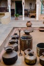 Vertical shot of the indian earthen copper pots in the old style Indian building in the daytime