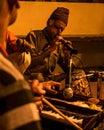 Vertical shot of an Indian musician playing a shehnai during a festival