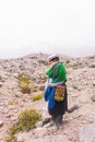 Vertical shot of the indigenous woman in the mountains. Ecuador, the Andes. Royalty Free Stock Photo