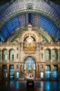 Vertical shot of the inside of the Antwerpen-Centraal railway station with a statue in Belgium