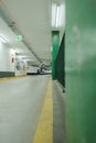 Vertical shot of inside of a big garage with green metallic railings