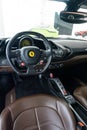 Vertical shot of an interior of a Ferrari 488 GTB with brown leather seats