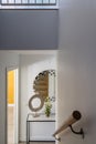 Vertical shot of the interior of a hallway under the lights in a house