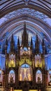 Vertical shot of the interior of Notre Dame Cathedral of Montreal, blue vaulted ceilings in Canada