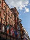 Vertical shot of the irish Arnotts pub with flags in Dublin, Ireland