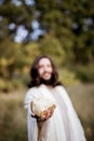 Vertical shot of Jesus Christ handing out bread with a blurred background