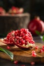 Vertical shot of juicy pomegranate fresh fruit uncovered lies on a bright background