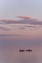 Vertical shot of the kayakers on the beautiful Lake Superior during the sunset Royalty Free Stock Photo