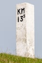 Vertical shot of a kilometer pole on the roadside Royalty Free Stock Photo