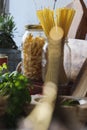 Vertical shot of a kitchen table with pastas in jars Royalty Free Stock Photo