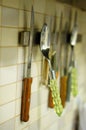 Vertical shot of kitchen utensils fixed on the wall with magnet Royalty Free Stock Photo