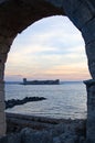 Vertical shot of Korykos Castle seen trhough arch during the sunset