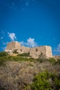 Vertical shot of the Kritinia Castle ruins under blue sky on a sunny day in Rhodes Island, Greece Royalty Free Stock Photo