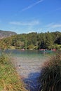 Vertical shot of lake Morsie Oko, Poland with poeple on canoes, trees and the sky in the background Royalty Free Stock Photo