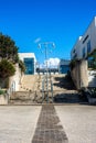 Vertical shot of lamppost on the stairs with buildings on the sides Royalty Free Stock Photo