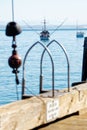 Vertical shot of a large boat sailing on the water visible from a dock Royalty Free Stock Photo