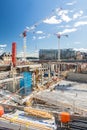 Large building site in urban area with cranes and foundations Royalty Free Stock Photo