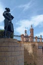 Vertical shot of a large statue constructed over a building