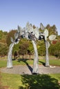 Vertical shot of Large steel Sculpture named Entwined with copper patina by Chris Moore in Auckland Botanical Gardens