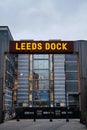 vertical shot of a Leeds dock sign lite up with Royal Armouries Museum