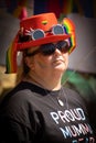 Vertical shot of an LGBT female wearing a hat with rainbows during a pride parade in Tonbridge