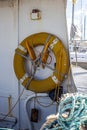 Vertical shot of a lifebuoy hanging on a wall of a boat on a port in Australia