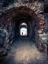 Vertical shot of light at the end of an old stone-made tunnel in Blankenburg, Harz, Germany