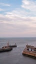 Vertical shot of the lighthouse,the beacon on west and east Whitby pier, in North Yorkshire, England Royalty Free Stock Photo