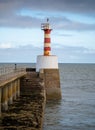 Vertical shot of a lighthouse at the coast in Amble, Northumberland, England Royalty Free Stock Photo