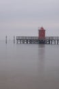 Vertical shot of the lighthouse of Lignano Sabbiadoro in gloomy weather in Udine, Italy