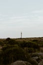 Vertical shot of a lighthouse in a mountainous area in San Vito Lo Capo, Sicily, Italy Royalty Free Stock Photo