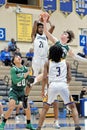 Vertical shot of Lighthouse and Oilers basketball players playing on a field at the competition