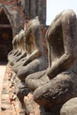 Vertical shot of a line of headless statues at Wat Chai Watthanaram temple, Ayutthaya, Thailand Royalty Free Stock Photo