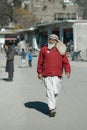 Vertical shot of a local Pakistani old man walking in the streets of Swat city, Pakistan