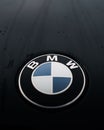 Vertical shot of a logo of BMW X4M on a rainy day Royalty Free Stock Photo